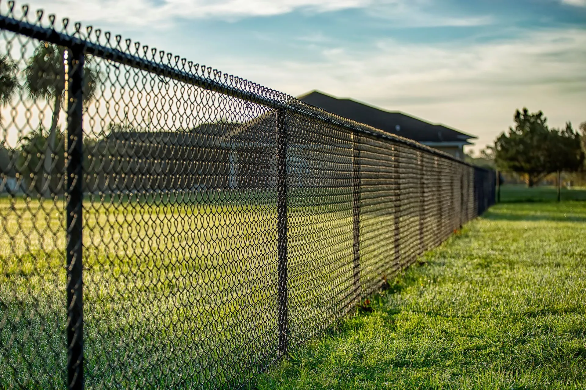 Galvanized chain link fence enclosing an open property